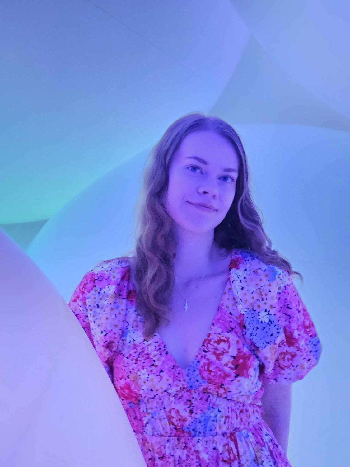 image of Emilia in a dress, smiling at the camera